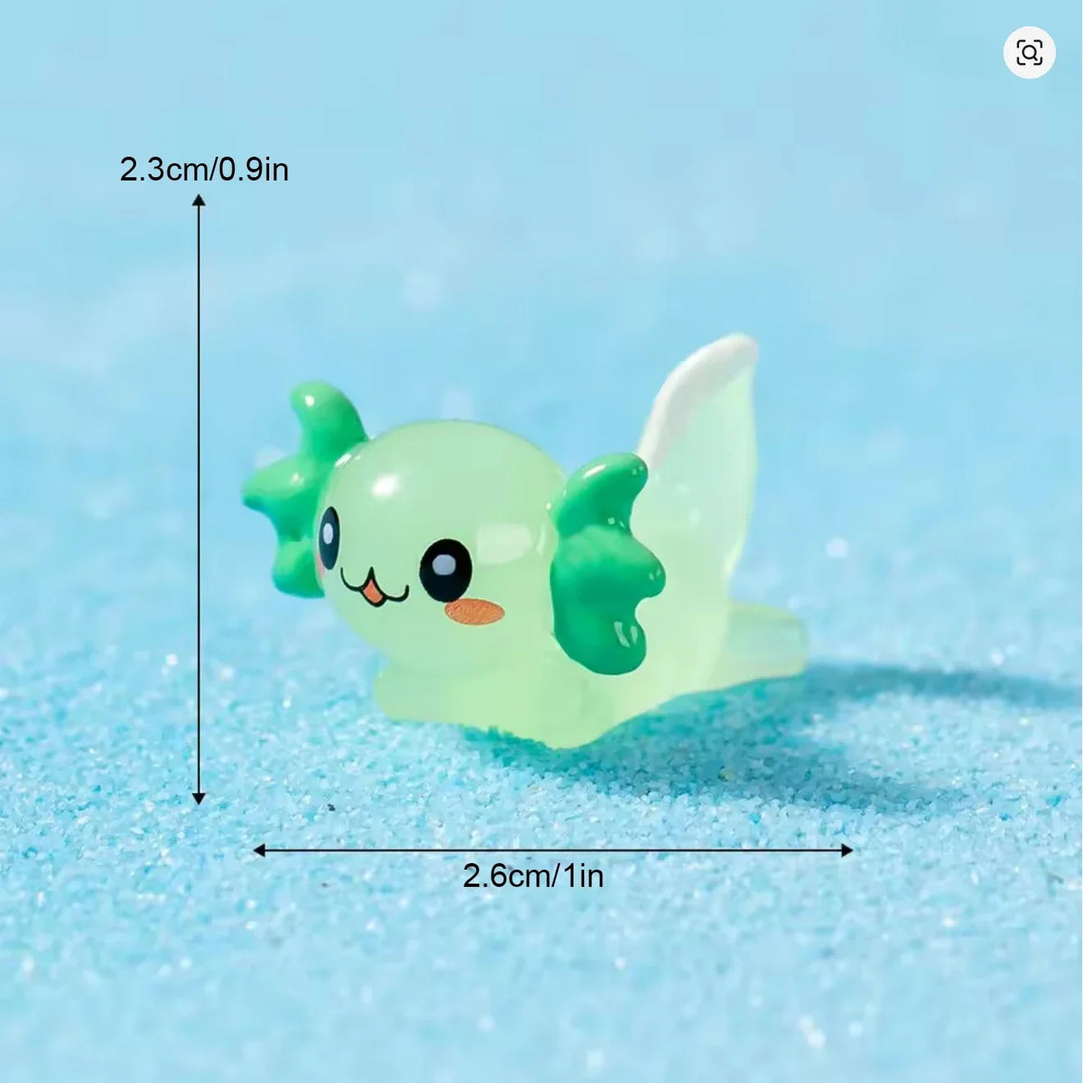 A small, translucent lime green resin axolotl figurine is shown against a light blue background.