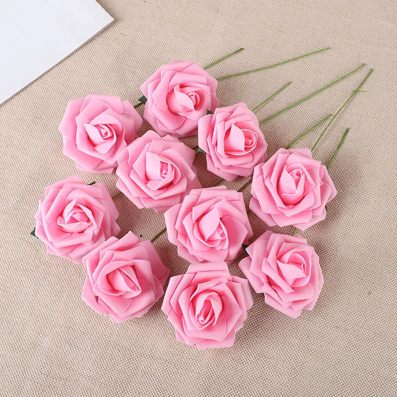 A collection of twenty pink foam rose stems arranged on a beige fabric background.