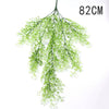 A long, delicate green artificial plant vine wall hanging measuring 82cm.