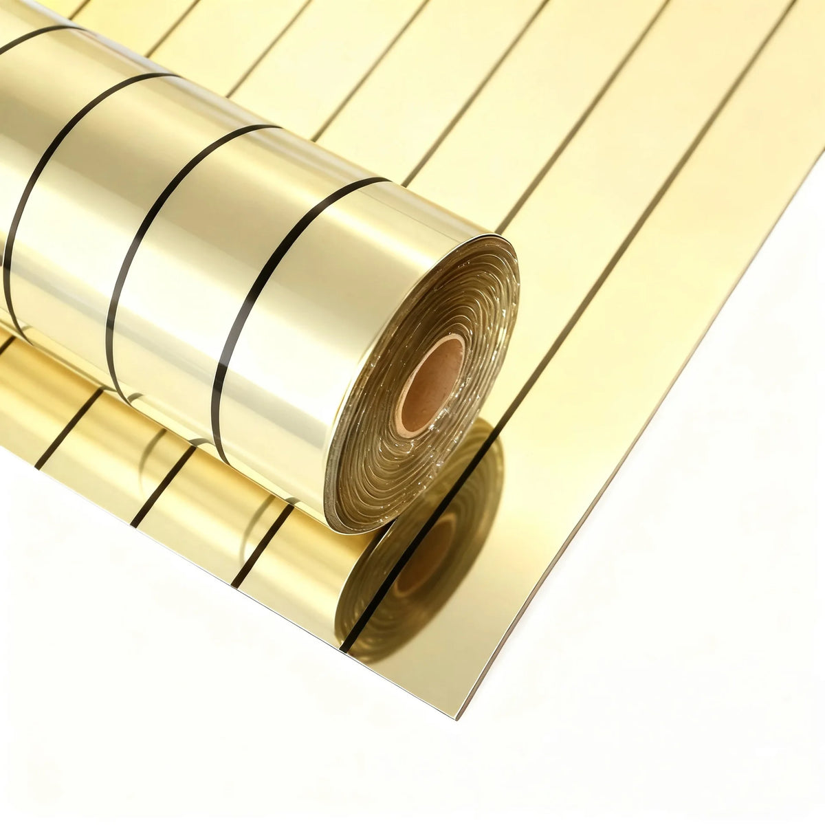 Rolls of gold self-adhesive mirror effect wallpaper stacked diagonally on a white surface.