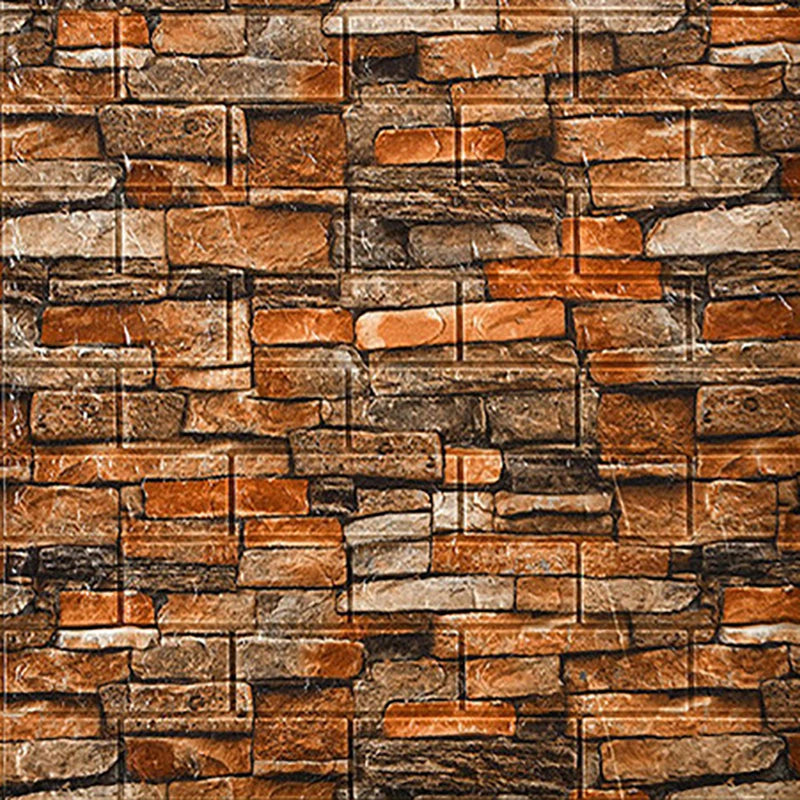 A textured stone veneer wall made of rectangular tiles in shades of brown, tan, and gray.