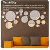 A wall decor set featuring a mirror and various circular acrylic discs used as hanging art or display boards.