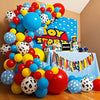 A colorful balloon arrangement featuring blue, yellow, and red latex balloons with cow print patterns for party decor.