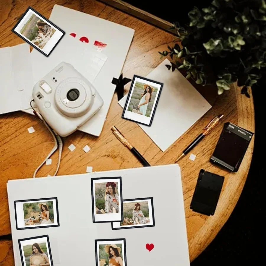A collection of magnetic mini photo frames and various small cameras are arranged on a wooden surface.
