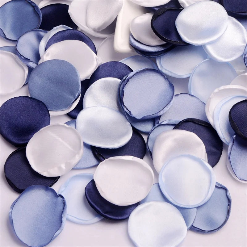 A collection of light blue, white, and navy silk rose petals for weddings and events.