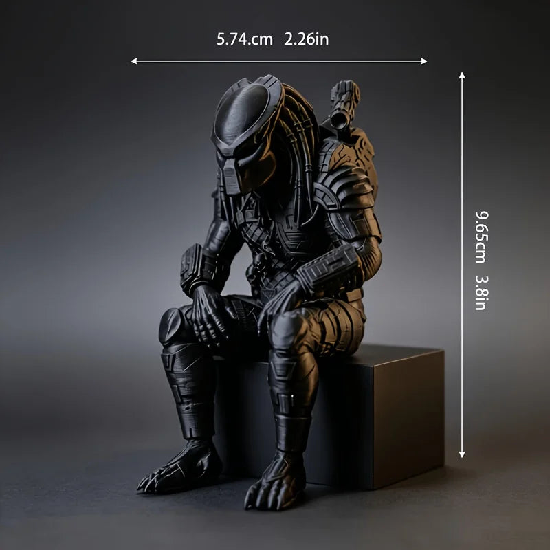A dark sci-fi figurine of a hunter in armor is shown seated on a black pedestal.