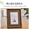 A wooden photo frame displaying the text Home is Where The Is, framed in dark wood.