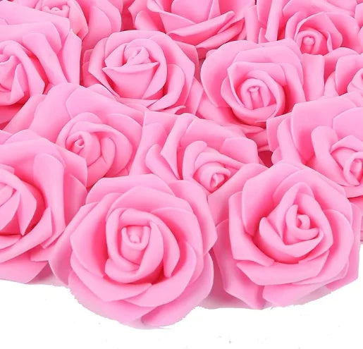 A close-up view of pink artificial foam rose decorations in various shades and sizes.