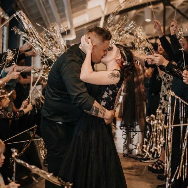 A couple is embracing amidst a shower of lighted tinsel wedding wands with LED glow.