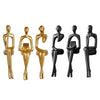 A set of five abstract thinker sculptures in gold and black resin finish.