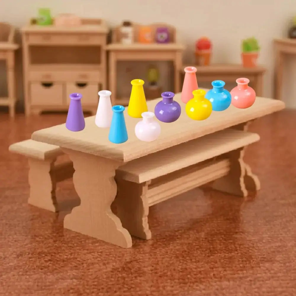 A wooden tray holds several miniature resin vases in various colors like yellow, purple, pink, and blue for dollhouse decor.