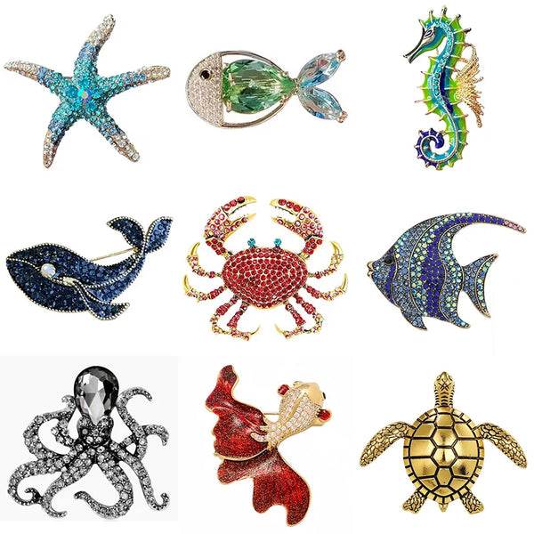 A set of vintage marine life brooch pins featuring starfish, fish, crab, octopus, and turtle designs.