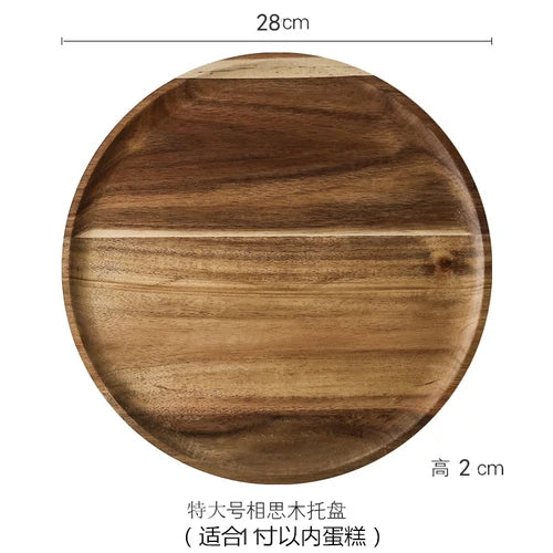 A round wooden cake tray with a glass dome cover, made from solid acacia wood.