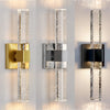 Modern bubble crystal LED wall sconces mounted on a white wall.