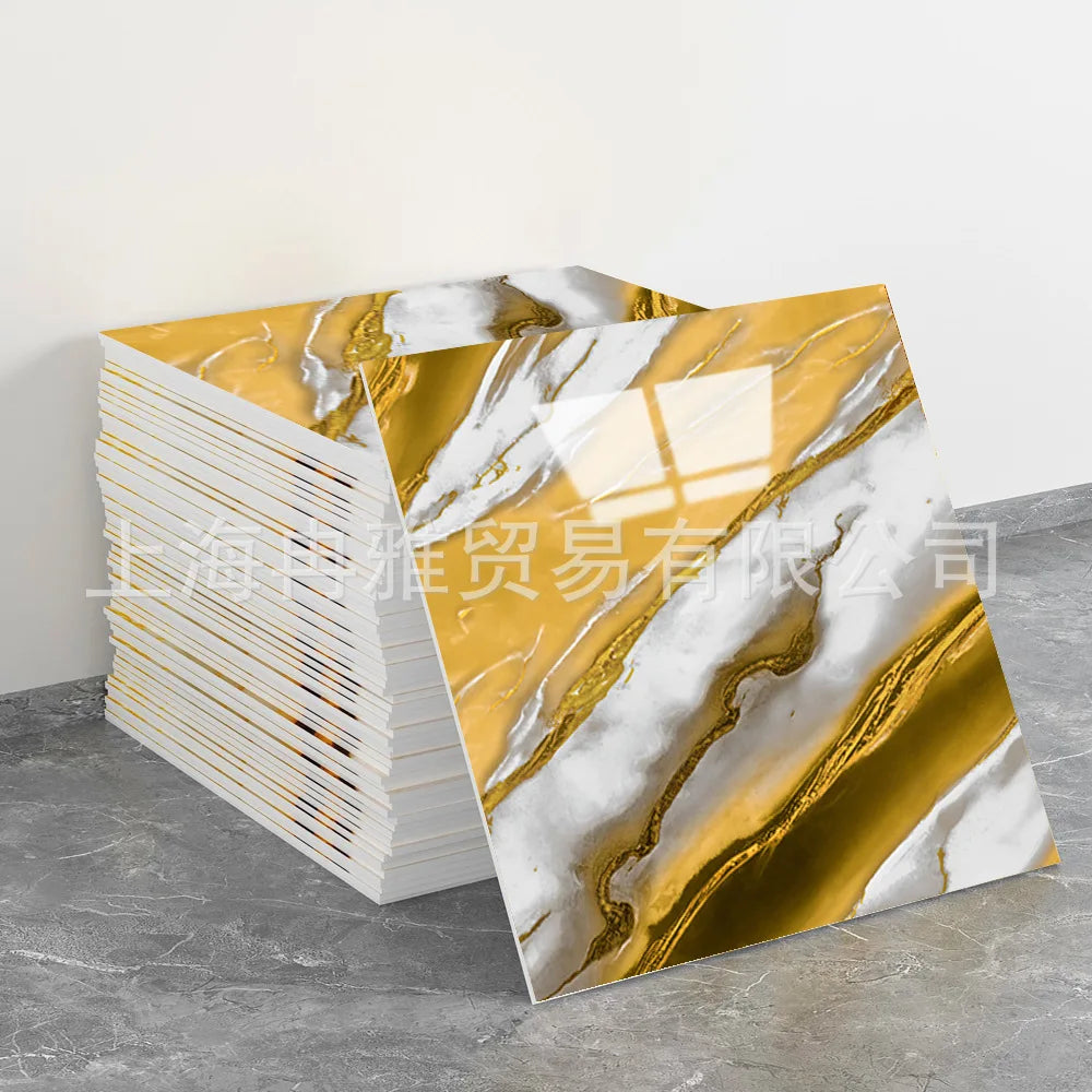 Gold and white marble pattern faux self-adhesive wall tiles displayed on a gray surface.
