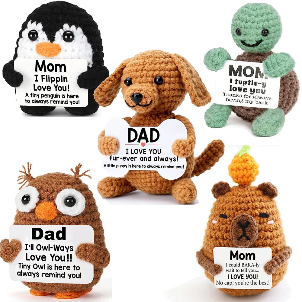 A collection of handcrafted crochet dog dolls for gifts, featuring a mom penguin, dad, and mom bear.
