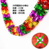 A close-up view of a colorful tinsel garland ribbon with shiny foil strips, used for Christmas tree and party decor.