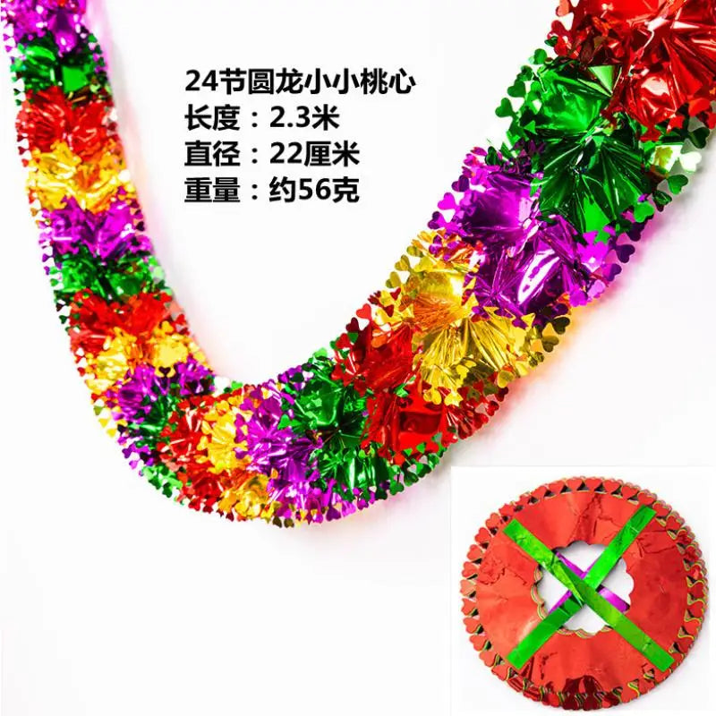 A close-up view of a colorful tinsel garland ribbon with shiny foil strips, used for Christmas tree and party decor.