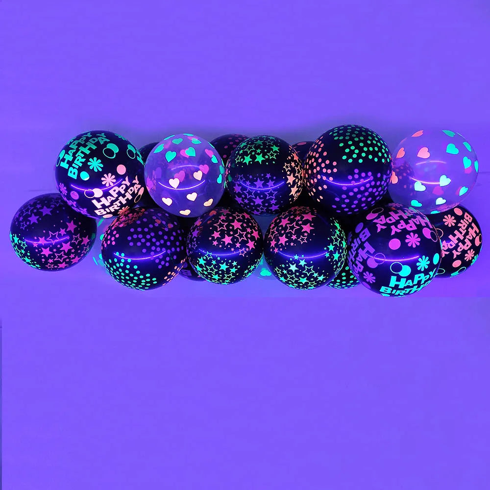 A row of dark purple and iridescent glow-in-the-dark latex balloons with pink confetti designs against a solid purple backgro