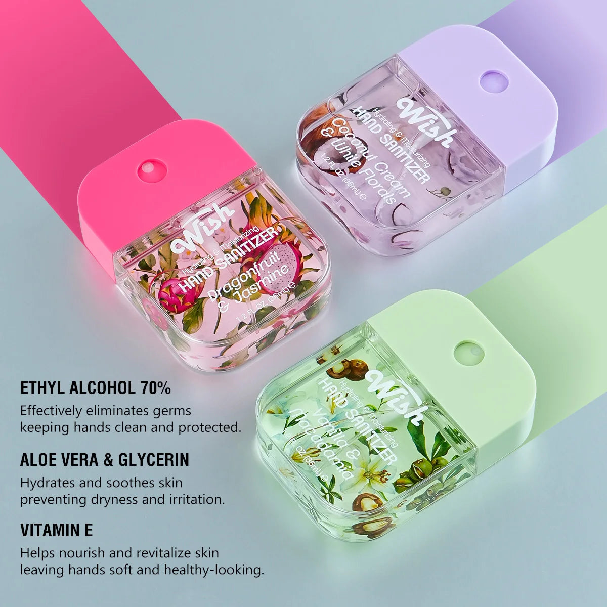 A pink and green moisturizing hand sanitizer spray bottle with a white cap and label is shown on a light surface.