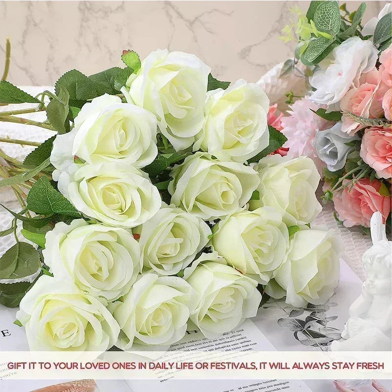A bouquet of artificial silk white roses arranged on a white surface.