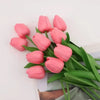 A bouquet of pink artificial tulips with green leaves arranged for home or wedding decor.