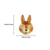 A golden-brown fox-like figurine with large ears and expressive eyes.