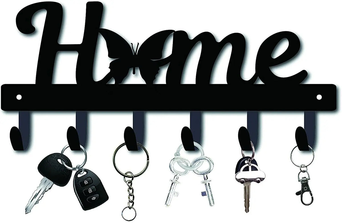 Decorative metal wall-mounted key holder with seven hooks and various keys.