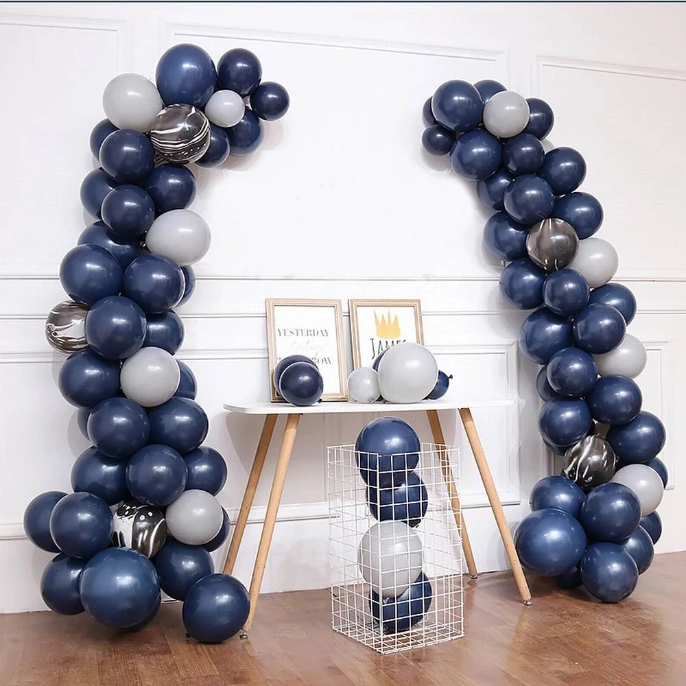A display of blue and gray latex balloons arranged in vertical columns for party decorations.