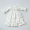 White vintage lace pajama set for a doll featuring ruffled sleeves and tiered skirt