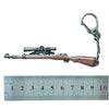 A realistic miniature alloy gun model keychain with a metal loop and a detailed firearm replica.