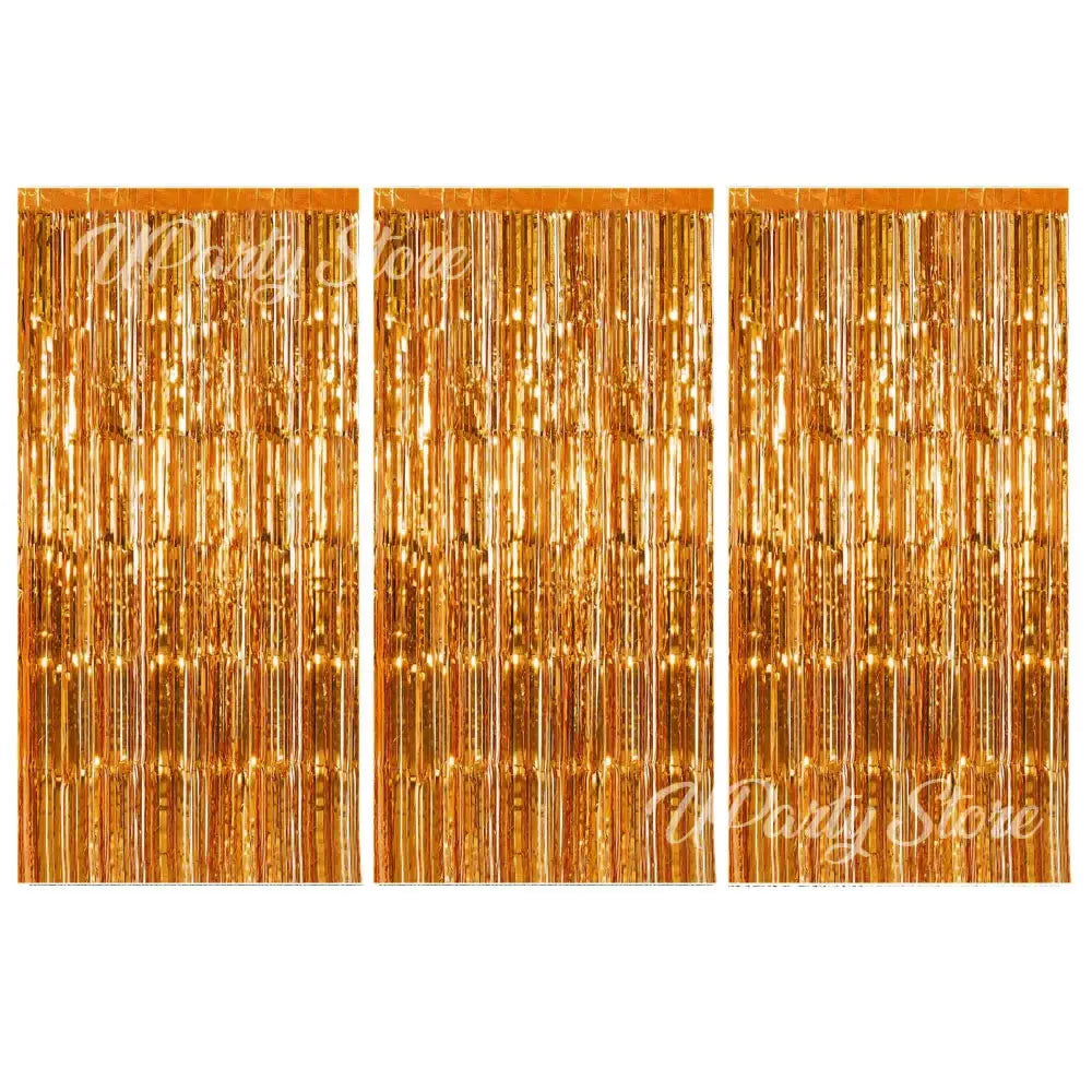 Three panels of vertical metallic gold fringe curtains used for party backdrop decor