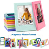 A collection of colorful magnetic photo frames, including a large mint green frame and several smaller pink and purple ones.