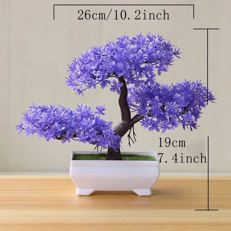 A small artificial tree bonsai decoration with purple blossoms planted in a white rectangular pot.