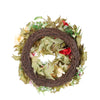 A wreath made of green leaves and red accents wrapped in brown twine for home decor
