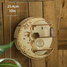 A round wooden wall shelf featuring a carved face and displaying crystals on three tiers.