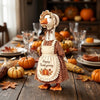 A decorative goose figure wearing an apron and headband, set for autumn Thanksgiving decor.