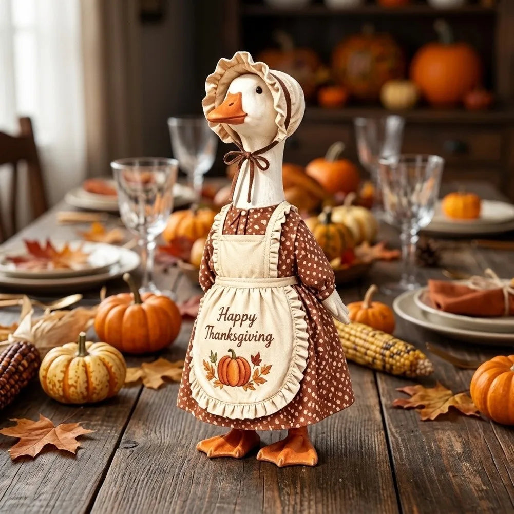 A decorative goose figure wearing an apron and headband, set for autumn Thanksgiving decor.