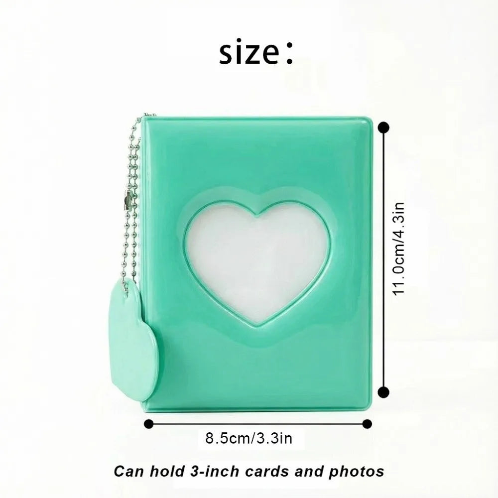 A mint green photo album with a heart-shaped cutout, designed to hold 3-inch cards and photos.