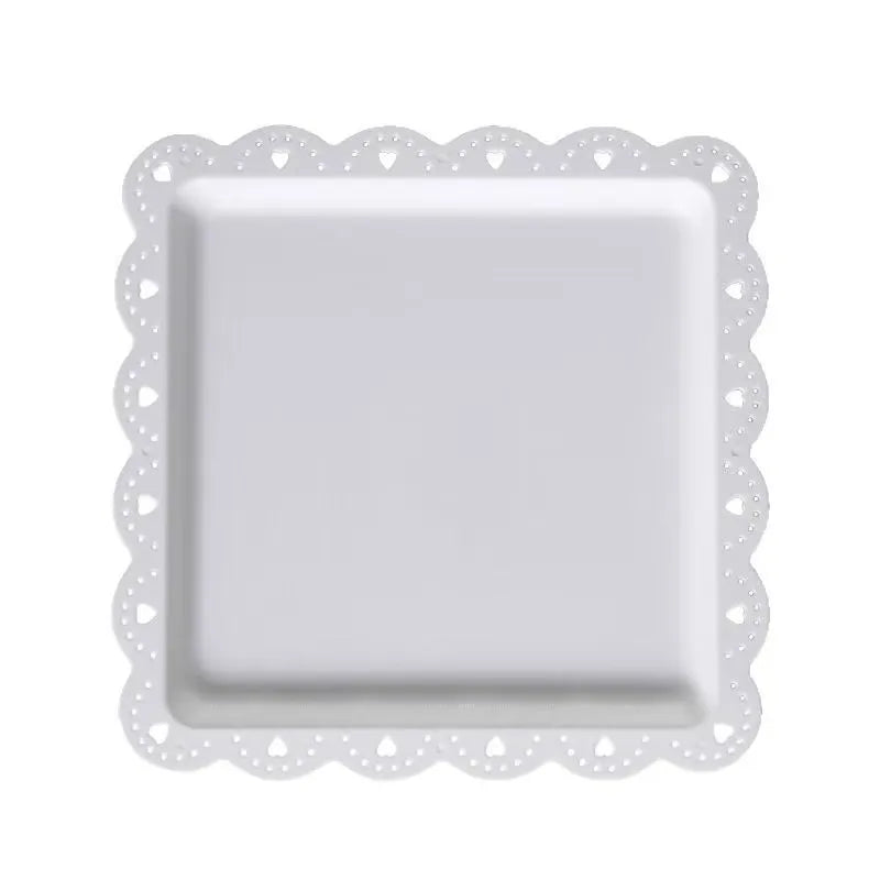 A white decorative food tray with a scalloped edge and square insert.