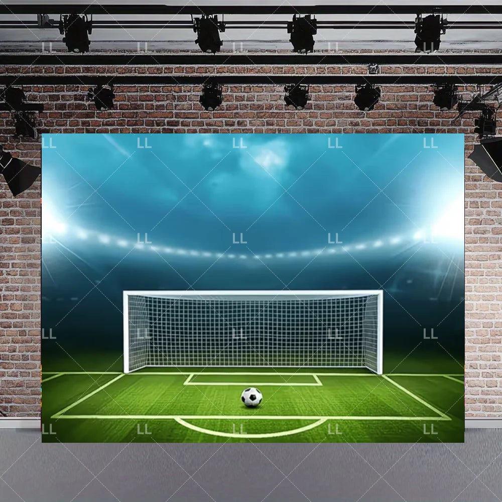 A soccer field backdrop featuring a green pitch and a white goal net against a blue sky background.