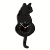 A black cat shaped pendulum wall clock with a moving tail.
