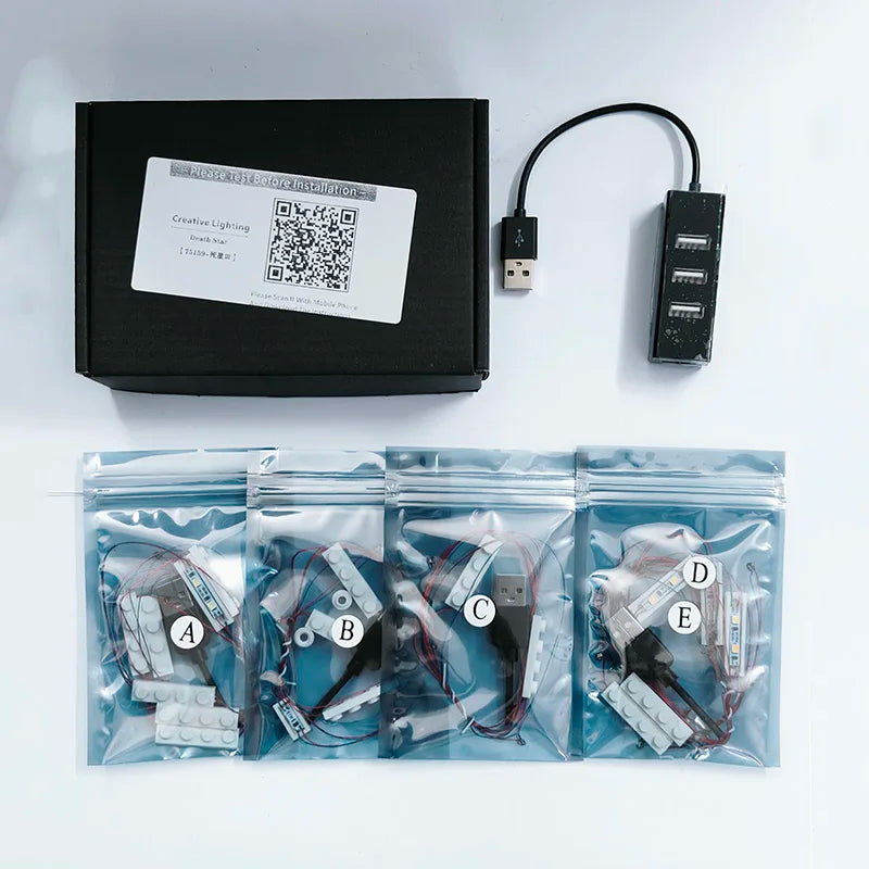 A kit containing various LED lighting components and a control box for building sets.