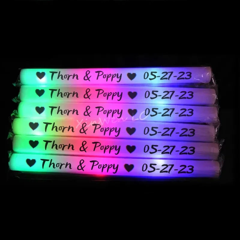 A set of glowing foam sticks with the text Thorn & Poppy and a date 05-27-23.