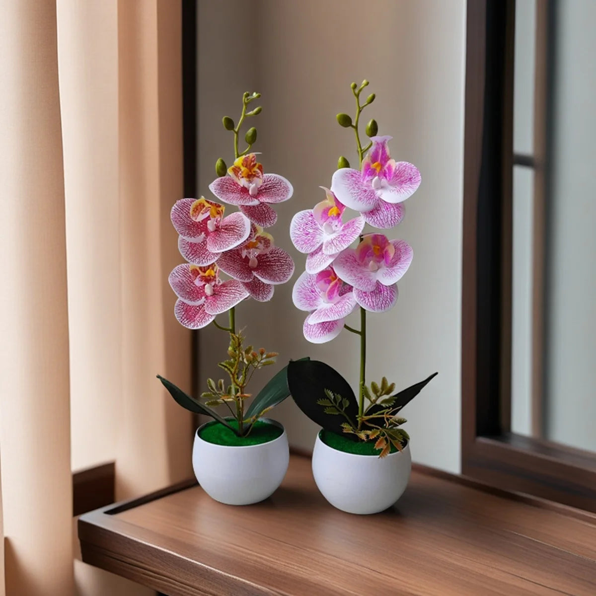 A pair of realistic artificial orchid potted plants with pink and purple flowers displayed on a wooden surface.