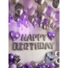 A display of purple and silver metallic balloons and heart-shaped balloons with Happy Birthday lettering.