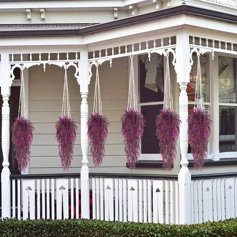 Purple silk morning glory vine hanging flowers decorating a white porch railing