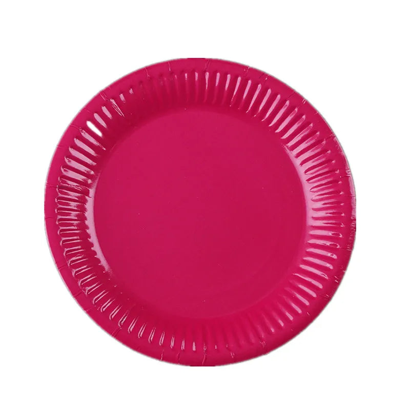 A solid magenta disposable plate with a ruffled edge.