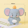 A cute light blue elephant cake topper with large ears and a small yellow chick, shown against a white background.