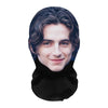 Realistic full-face cosplay mask of a young man with dark, wavy hair and a slight smile.